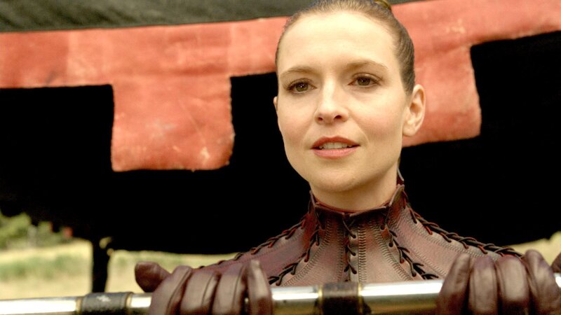 woman in leather armor holding weapon