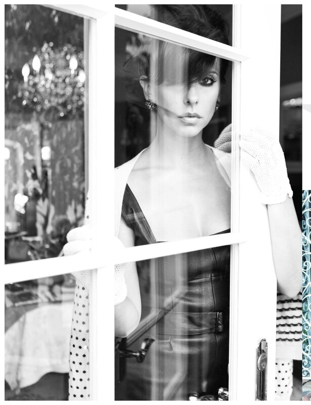 woman in leather dress at window
