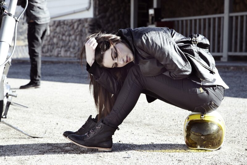woman in leather gear crouching