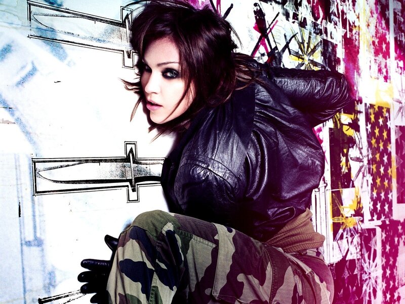 woman in leather jacket against graffiti wall