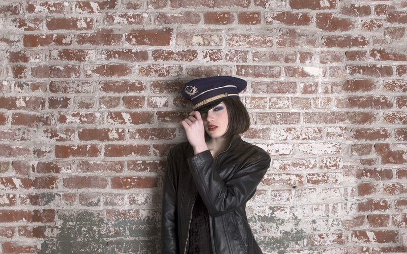 woman in leather jacket and cap
