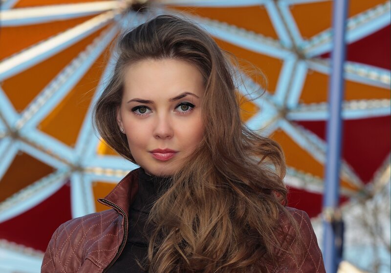 woman in leather jacket at amusement park