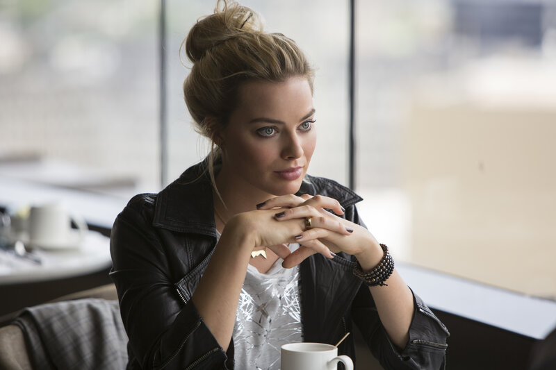 woman in leather jacket at cafe