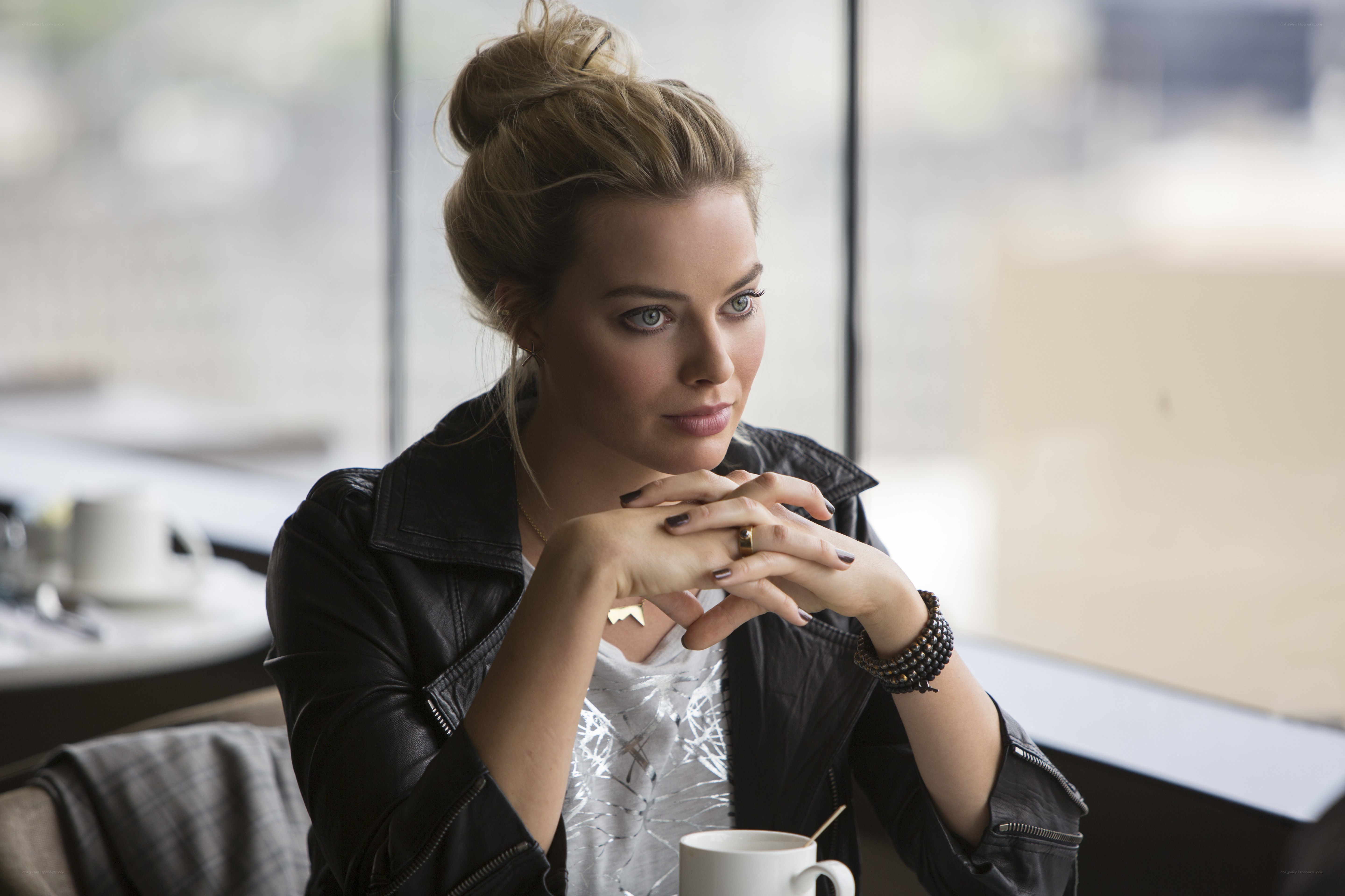 woman in leather jacket at cafe