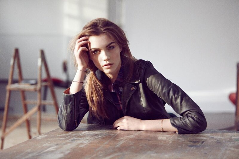 woman in leather jacket at table