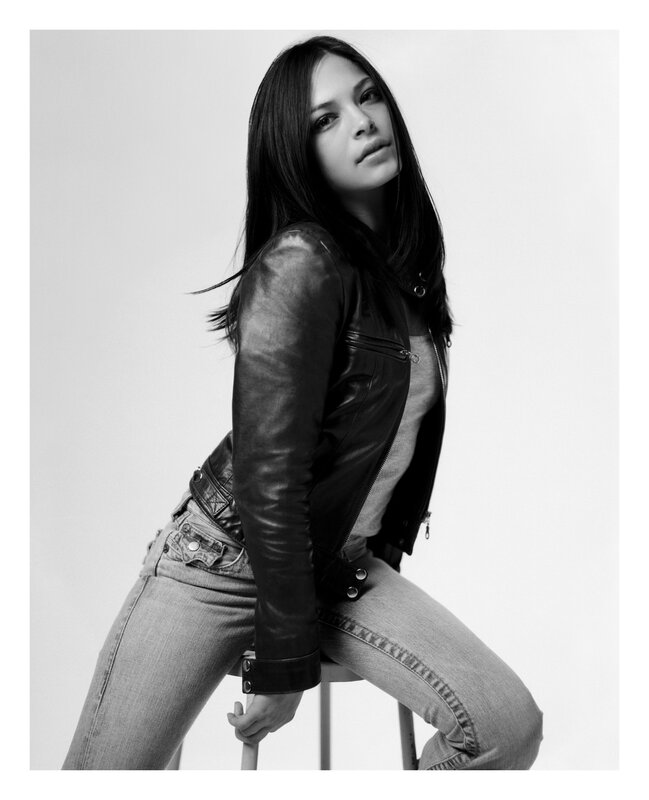Woman in Leather Jacket — Black, Confident, Photograph, Leather Jacket, Jeans, Stool, White