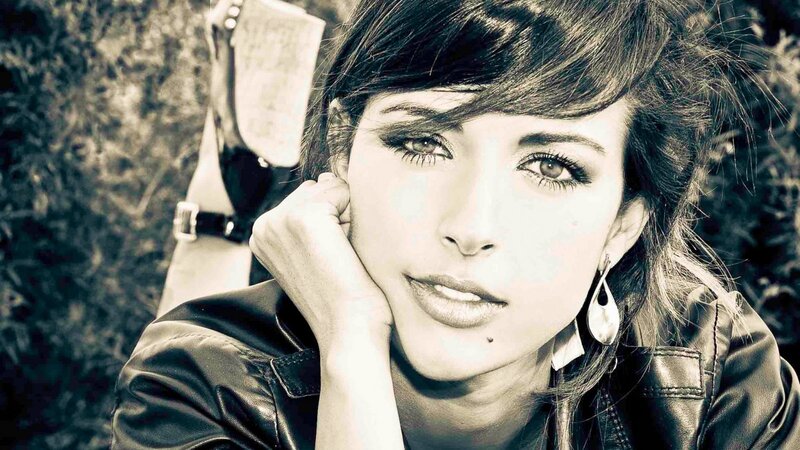 Woman in Leather Jacket — Black, Contemplative, Photograph, Leather Jacket, Earrings