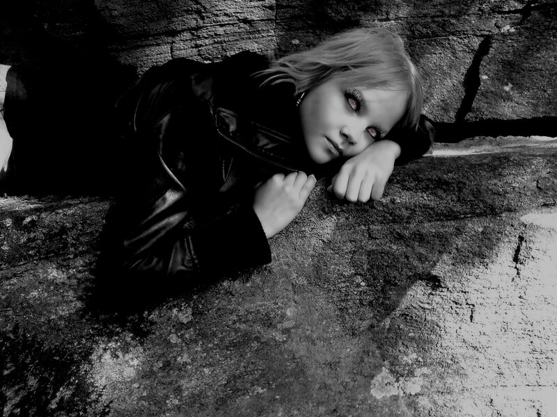 Woman in Leather Jacket — Black, Dramatic, Photograph, Stone Wall