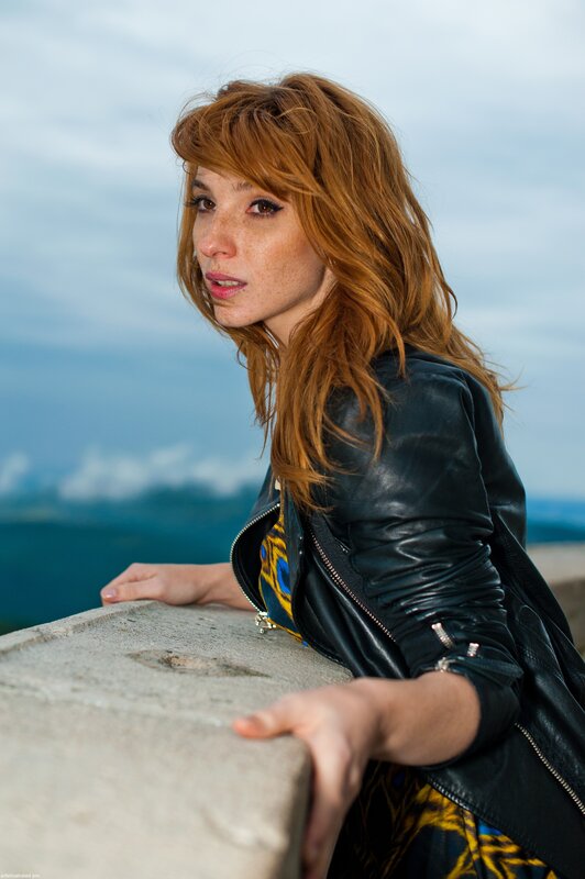 woman in leather jacket by the sea