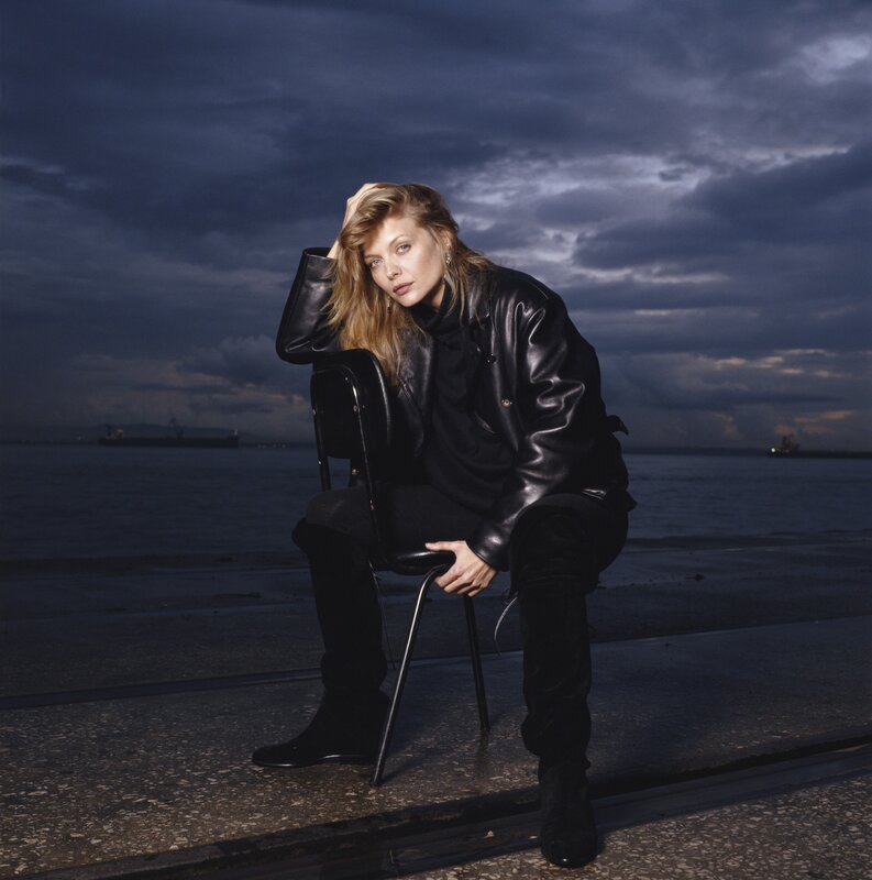 Woman in leather jacket by the water