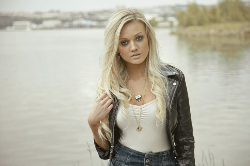 woman in leather jacket by water