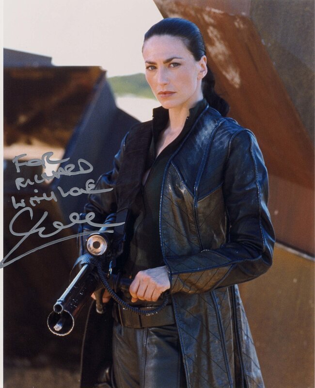 Woman in leather jacket holding weapon