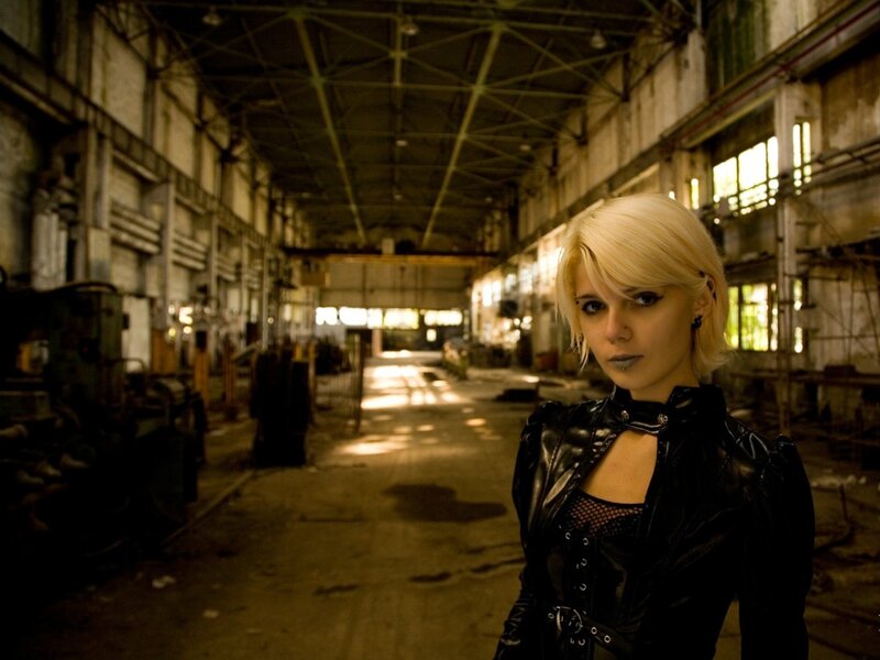 Woman in leather jacket in warehouse