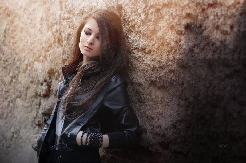 woman in leather jacket leaning