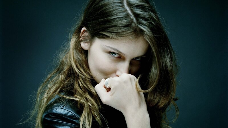 woman in leather jacket looking at camera