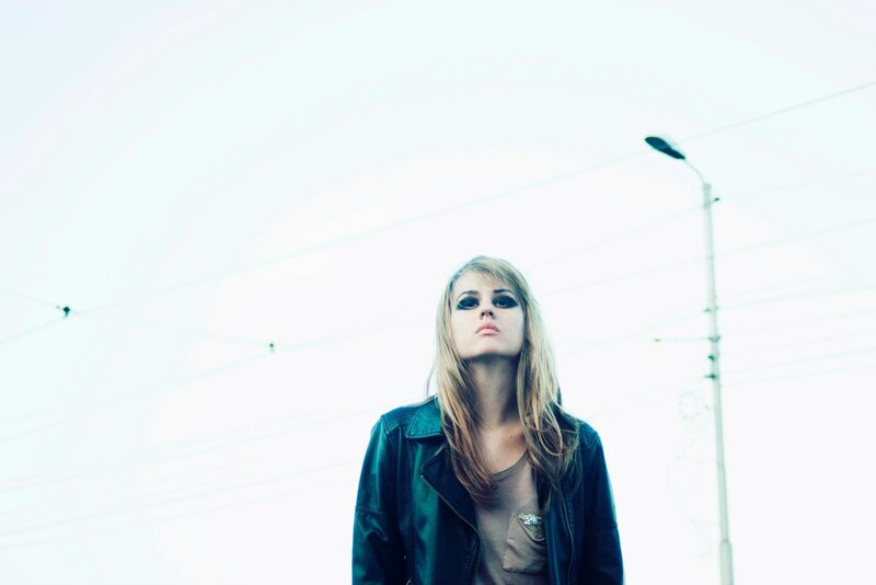woman in leather jacket looking up