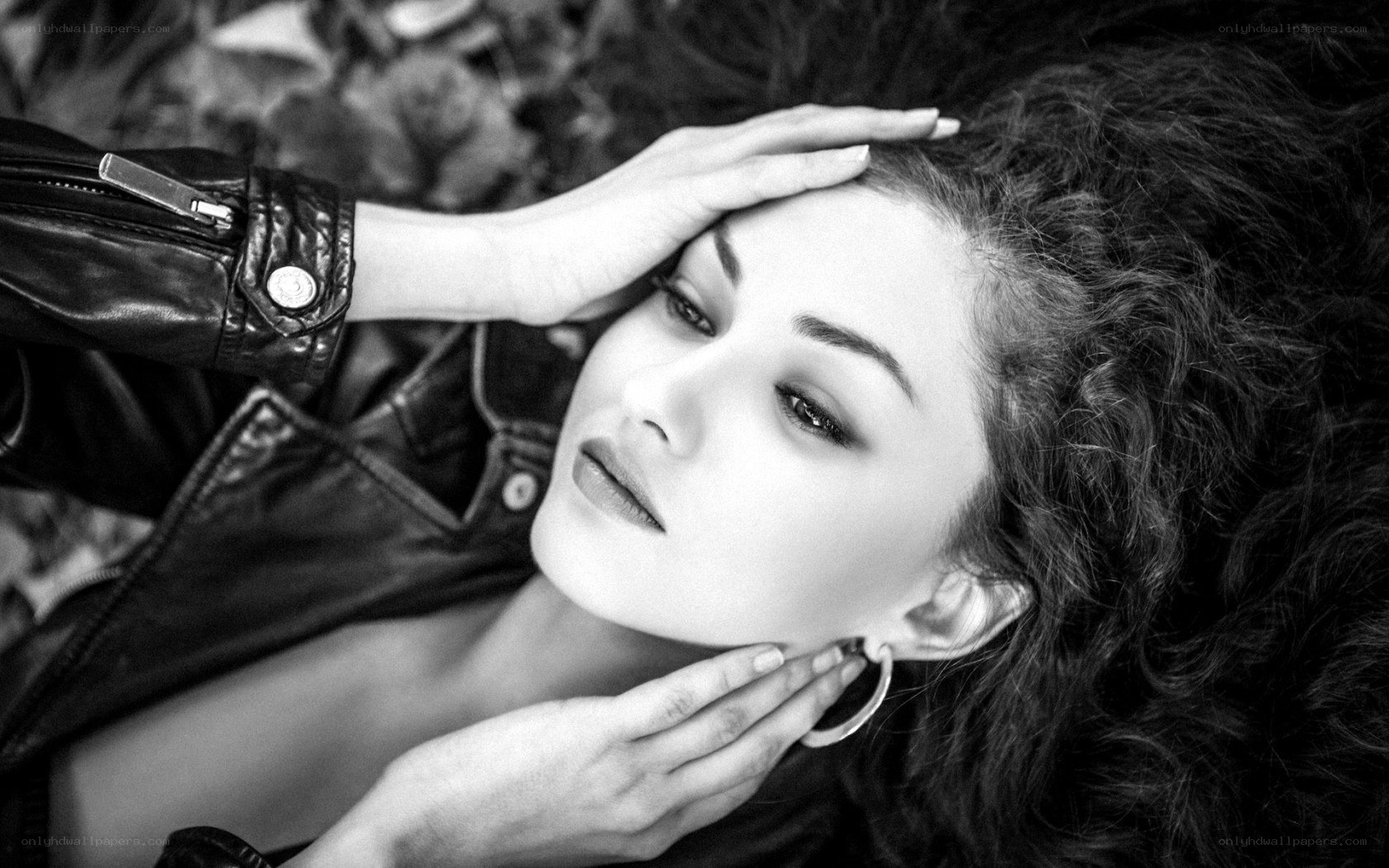 woman in leather jacket lying down