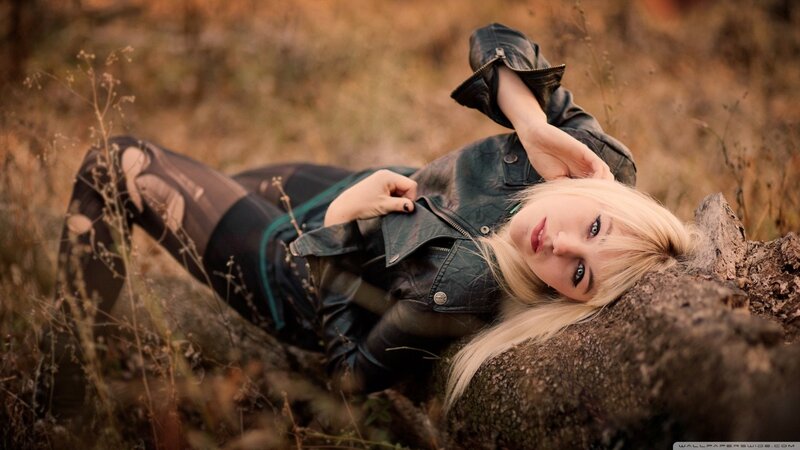 woman in leather jacket lying down