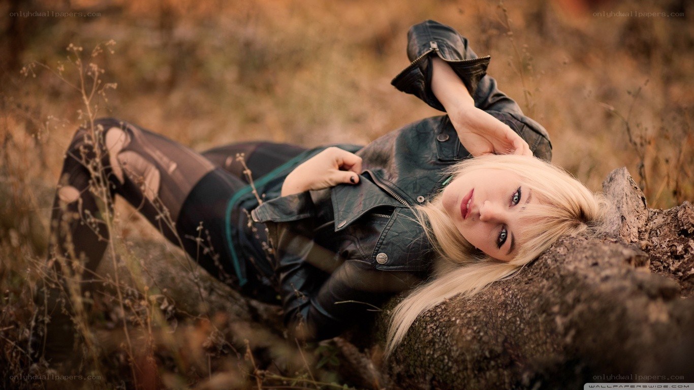 woman in leather jacket lying down