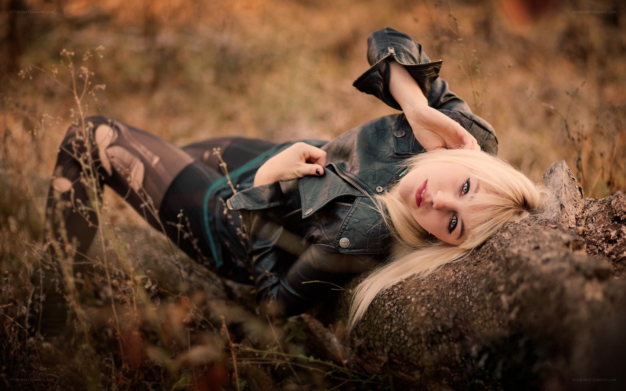 woman in leather jacket lying down