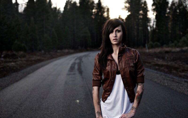 woman in leather jacket on road