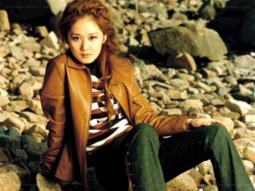 woman in leather jacket on rocks