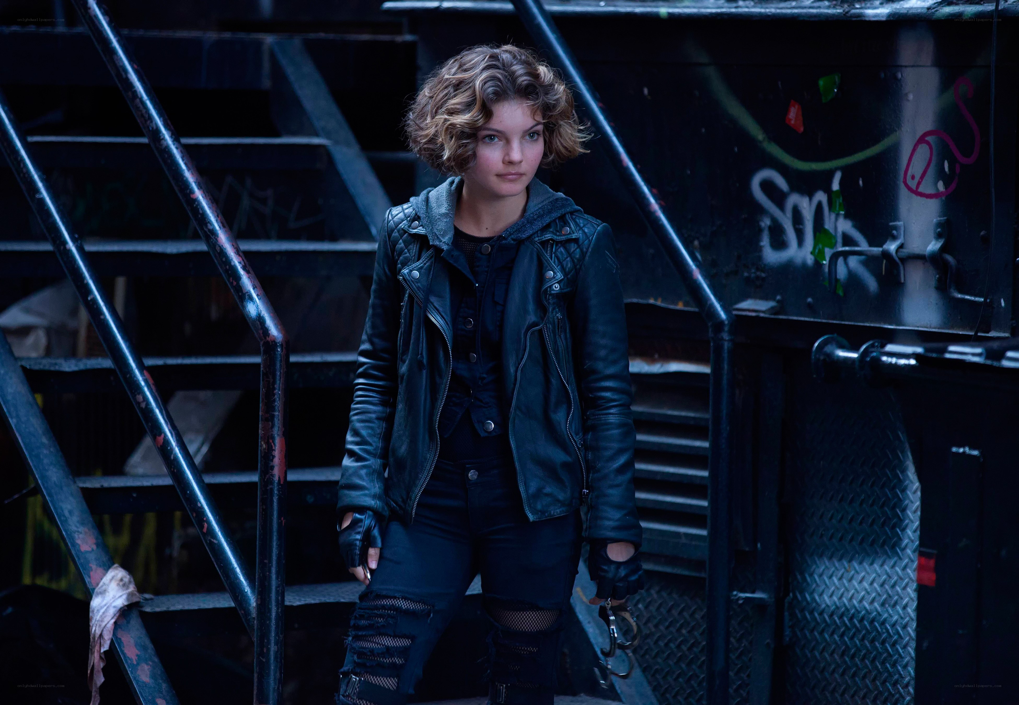 woman in leather jacket on stairs
