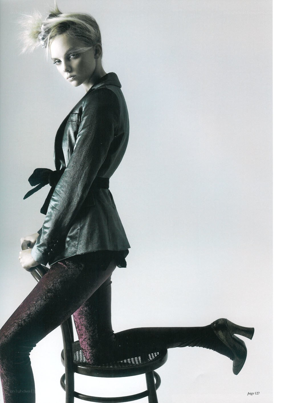 woman in leather jacket on stool