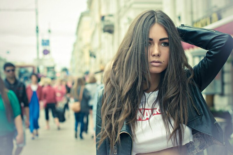 woman in leather jacket on street