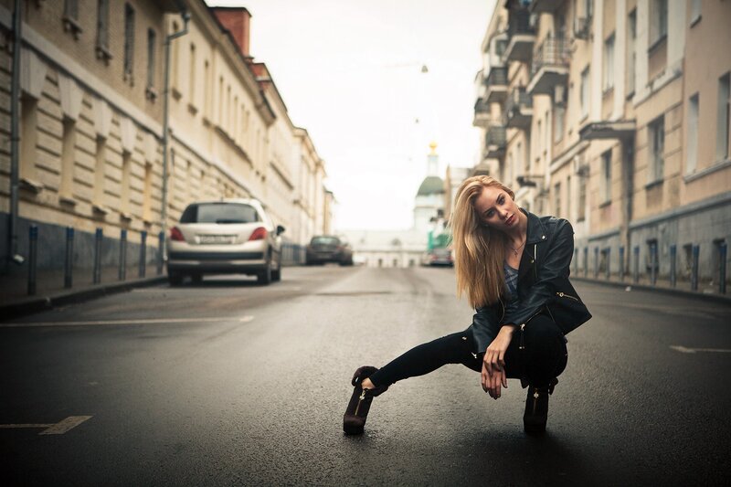 Woman in leather jacket on street