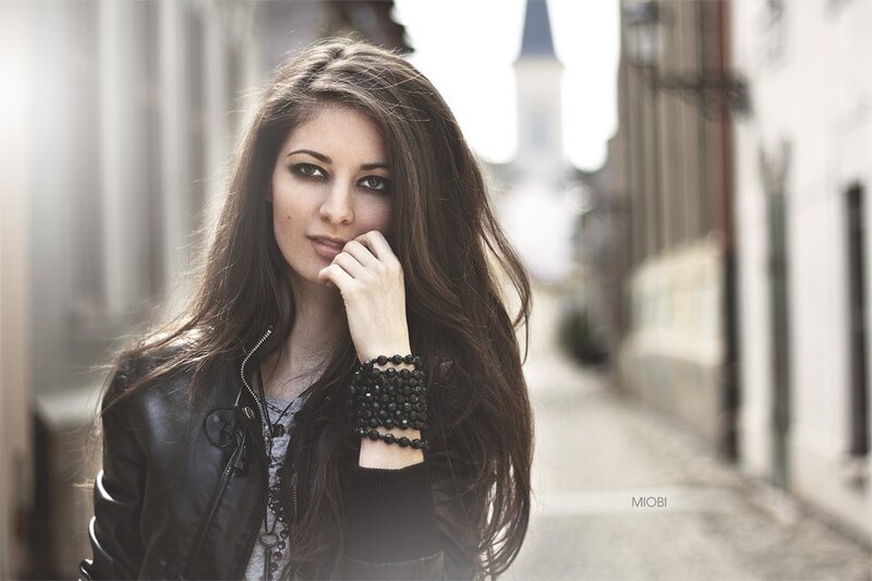 woman in leather jacket on street