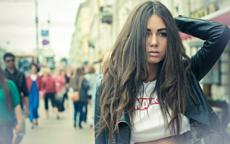 woman in leather jacket on street