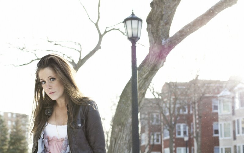 woman in leather jacket outdoors