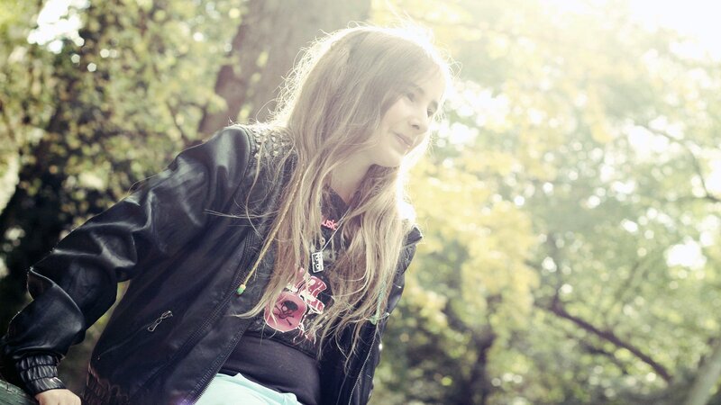 woman in leather jacket outdoors