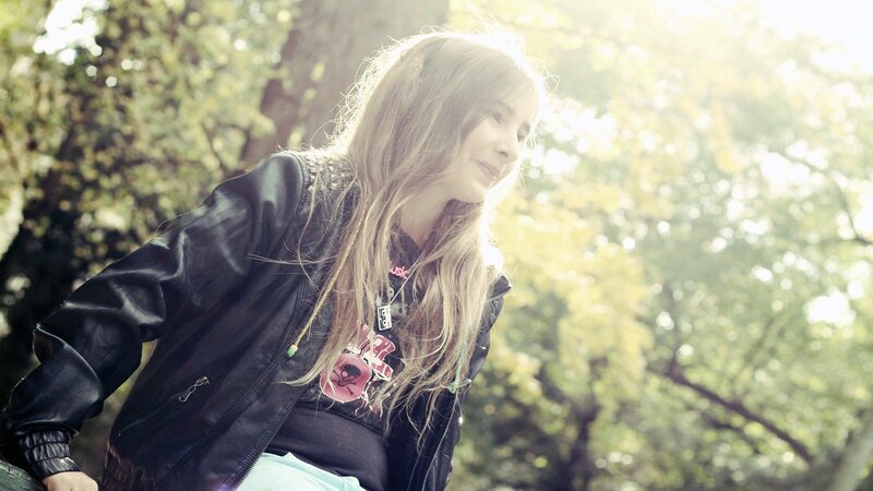 woman in leather jacket outdoors