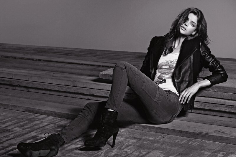 Woman in leather jacket sitting