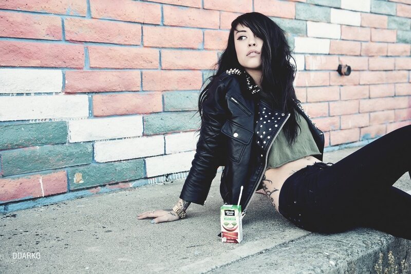 woman in leather jacket sitting on curb