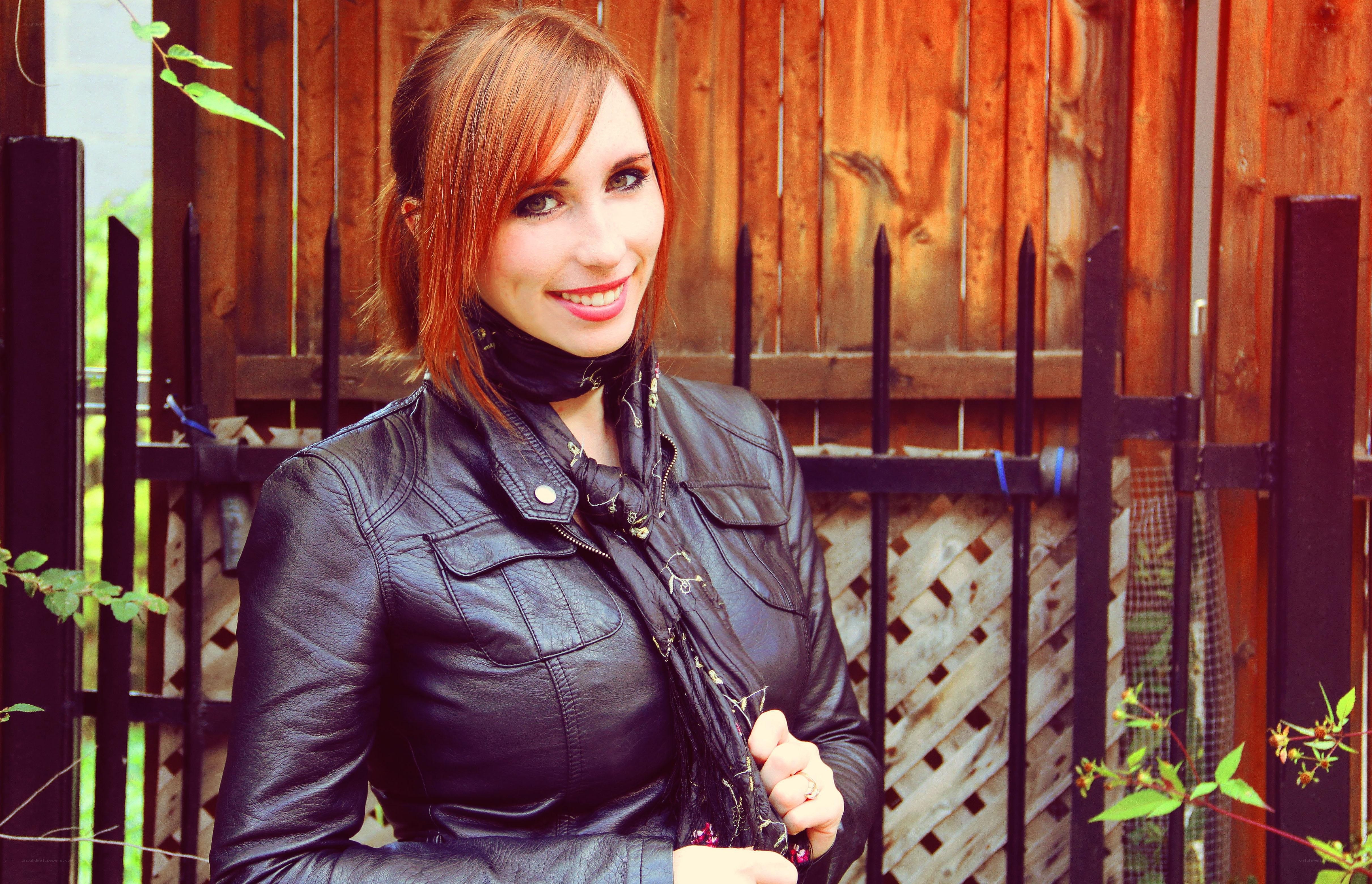 woman in leather jacket smiling