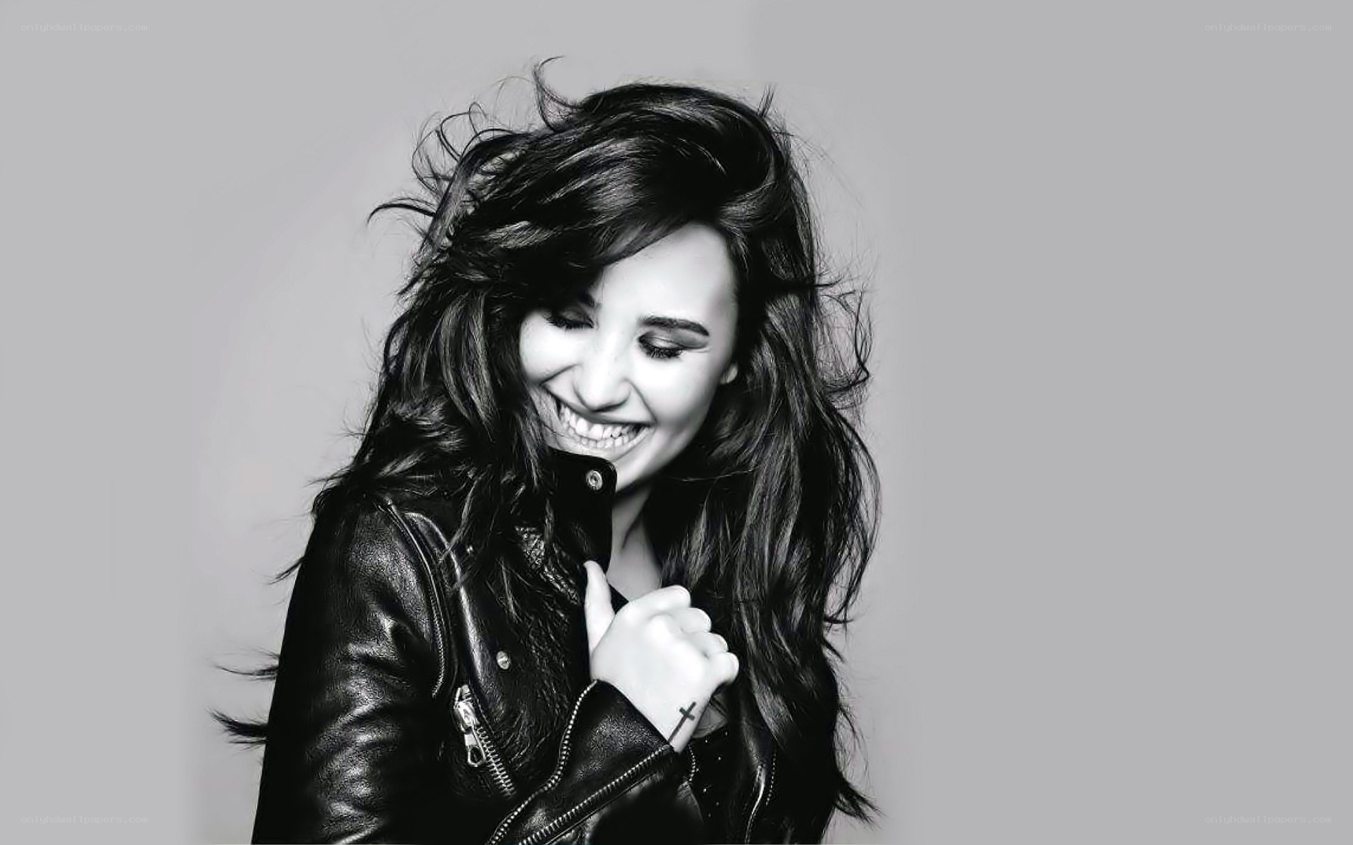 woman in leather jacket smiling