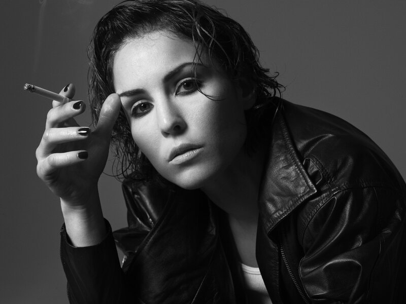 woman in leather jacket smoking