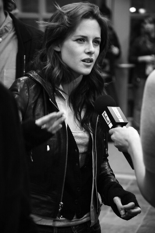 woman in leather jacket speaking