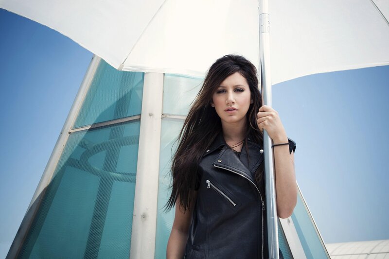 woman in leather jacket under umbrella