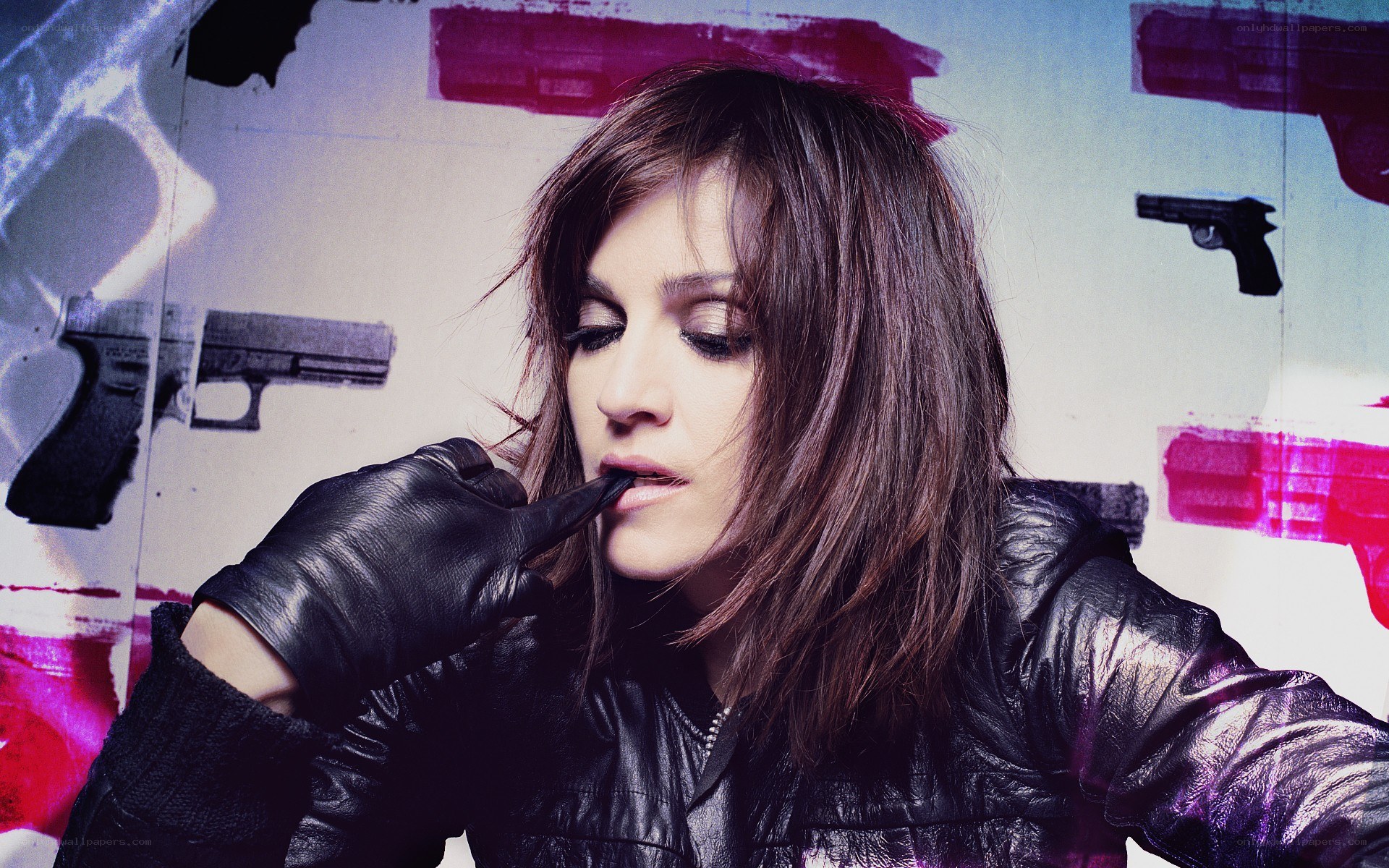 woman in leather jacket with guns