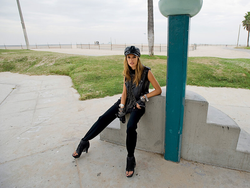 Woman in leather outfit at beach