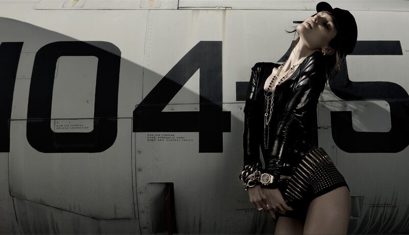Woman in leather outfit near airplane