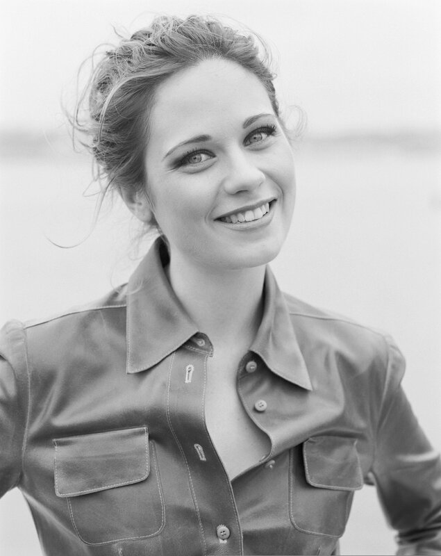 woman in leather shirt smiling