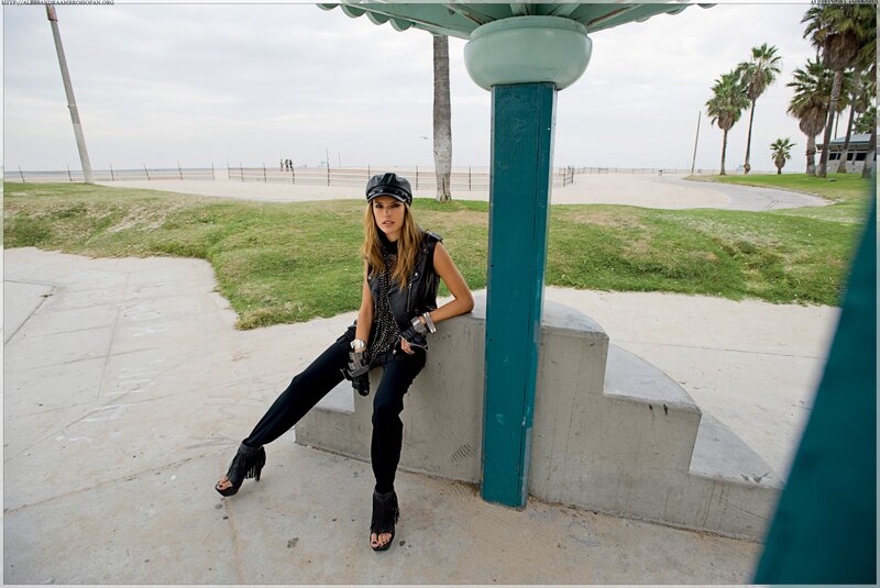 Woman in leather vest at beach