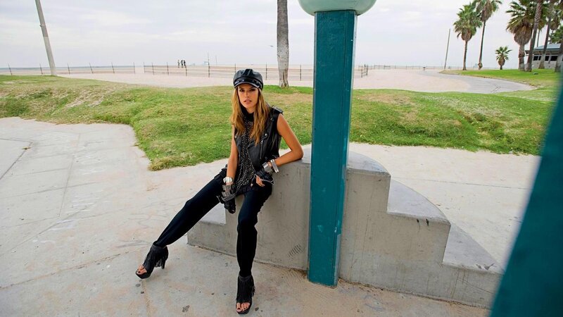 woman in leather vest at beach