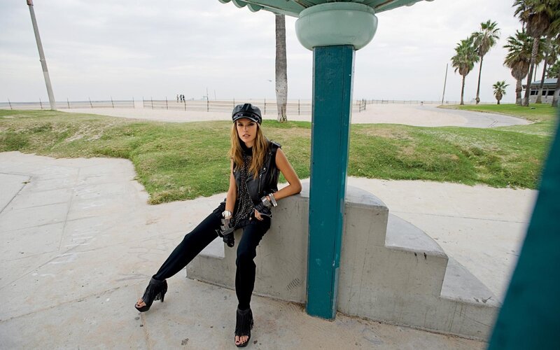 Woman in leather vest at beach