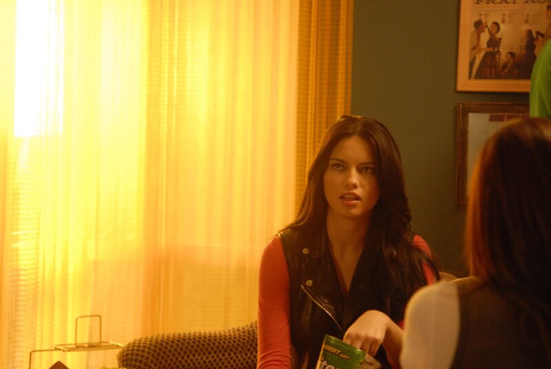 woman in leather vest sitting